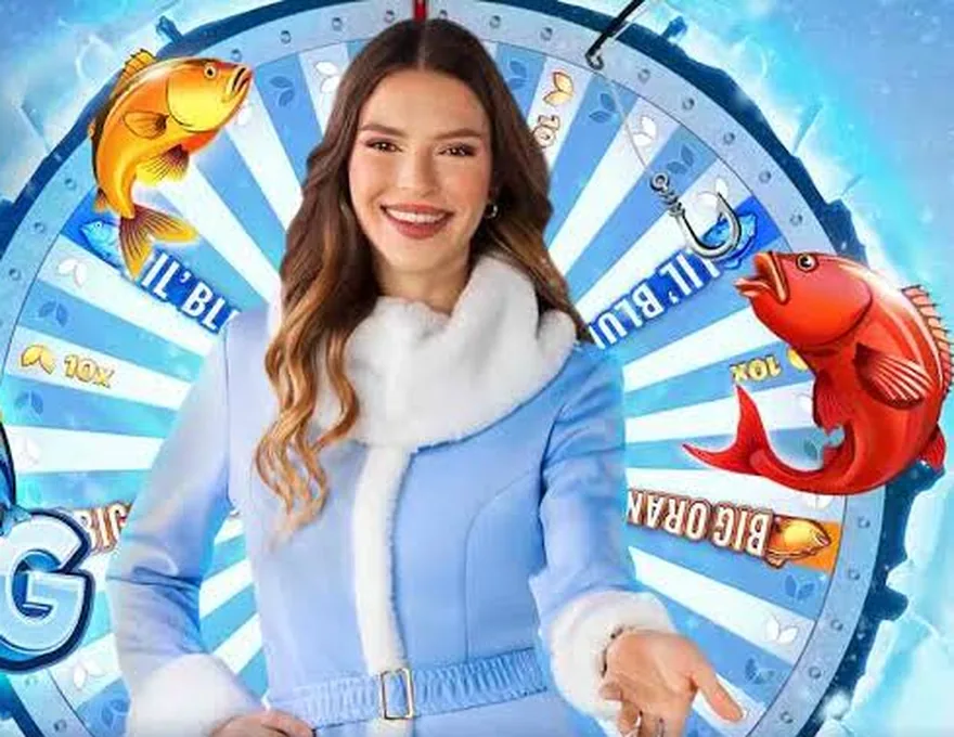 Ice Fishing Live host next to the betting wheel with Lil' Blues and Big Oranges segments